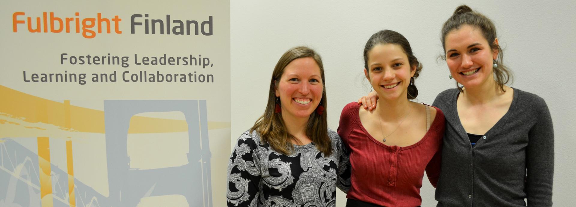 2017 Roth Endowment Award winners smiling next to Fulbright Finland roll-up