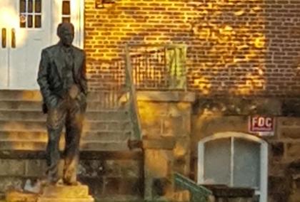 The statue of J. William Fulbright at the University of Arkansas campus on a sunny autumn day