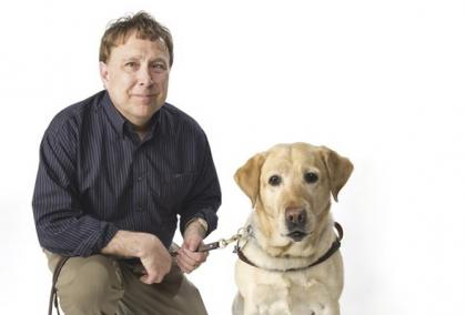 Poet, disability advocate and Fulbright alumnus Stephen Kuusisto with his guide dog, a labrador retriever.