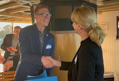 Thomas Flanagan, Executive Director of Finlandia Foundation National and Terhi Mölsä, CEO of the Fulbright Finland Foundation, shaking hands after signing a MoU at a river cruise in Mystic, CT.