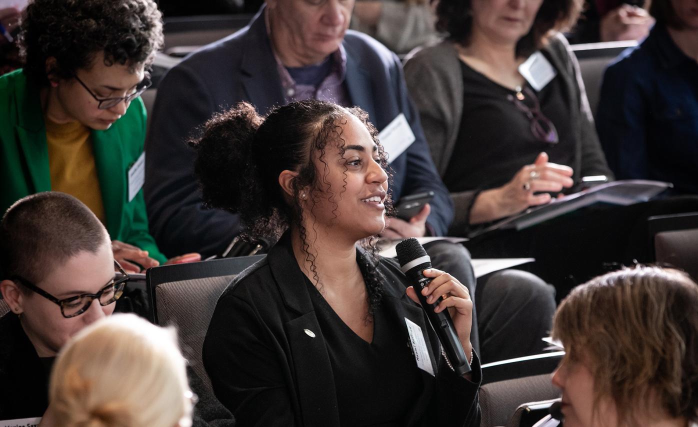 Naomi Kellogg, U.S. Fulbright grantee from Norway asking a question from an audience.