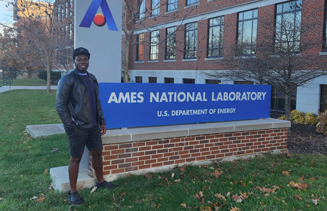 Emmanuel Abu-Danso in front of Ames National Laboratory sign