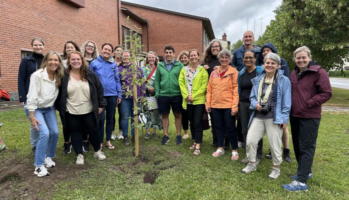 Fulbright-Hays fellows around a tree they planted at the University of Eastern Finland Joensuu campus.