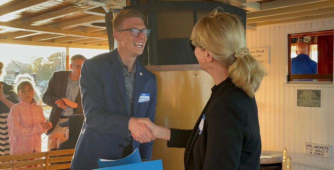 Thomas Flanagan, Executive Director of Finlandia Foundation National and Terhi Mölsä, CEO of the Fulbright Finland Foundation, shaking hands after signing a MoU at a river cruise in Mystic, CT.