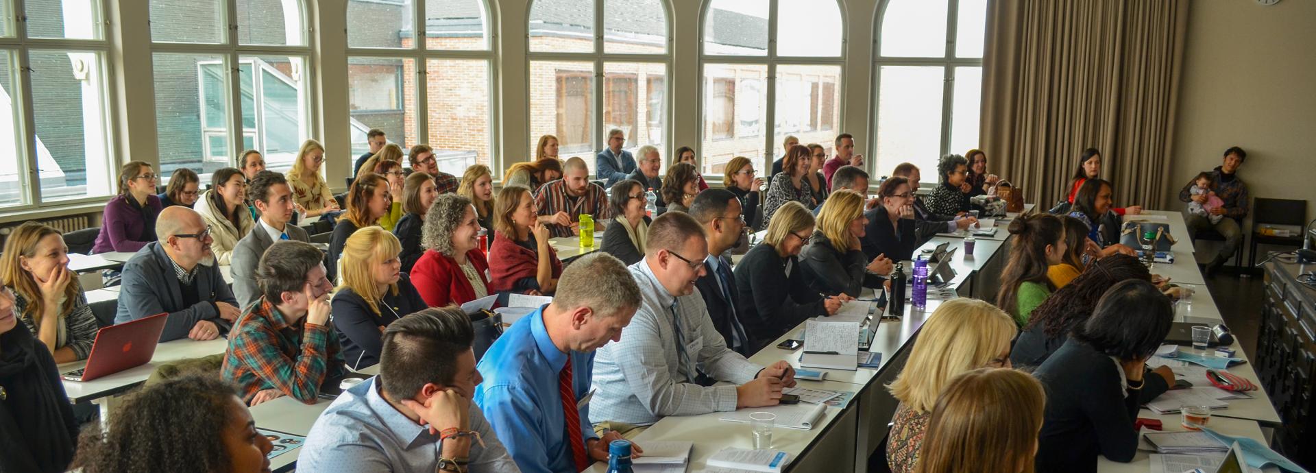 Audience at the Fulbright Forum 2019 smiling and listening to a presentations