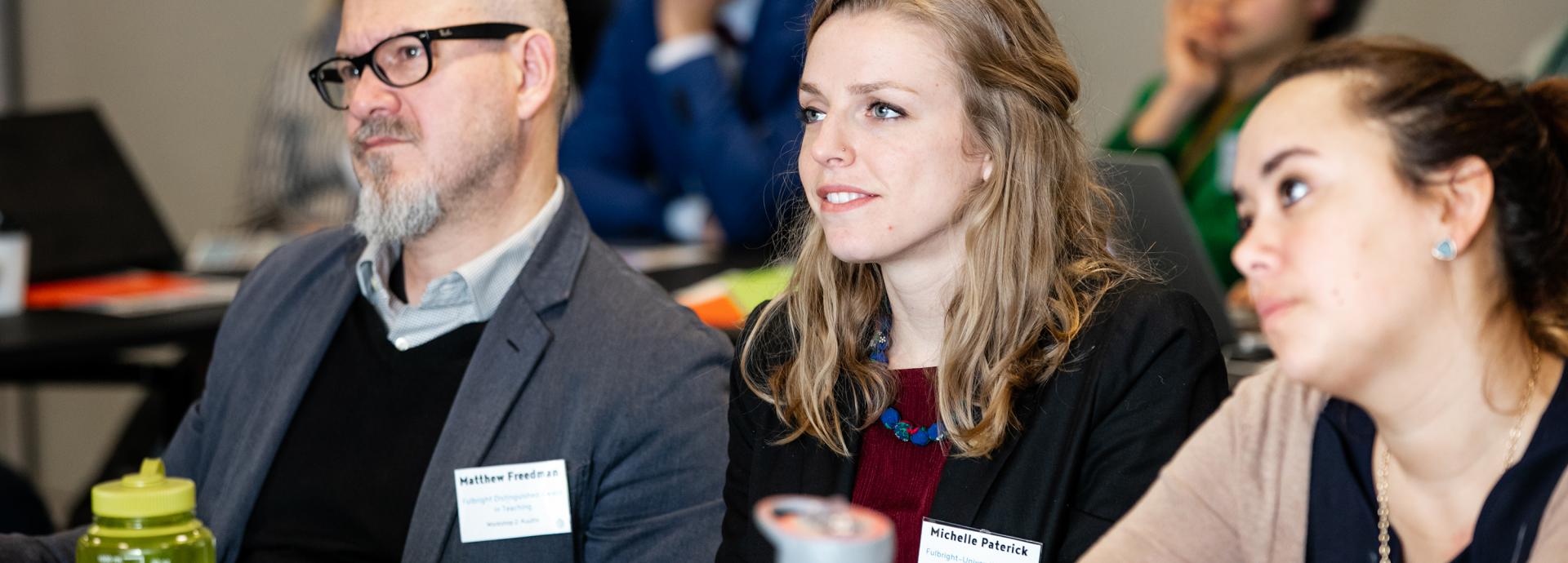 U.S. Fulbrighters Matthew Freedman, Michelle Paterick and Julia Miller concentrating on a presentation during Truth Matters seminar in Helsinki