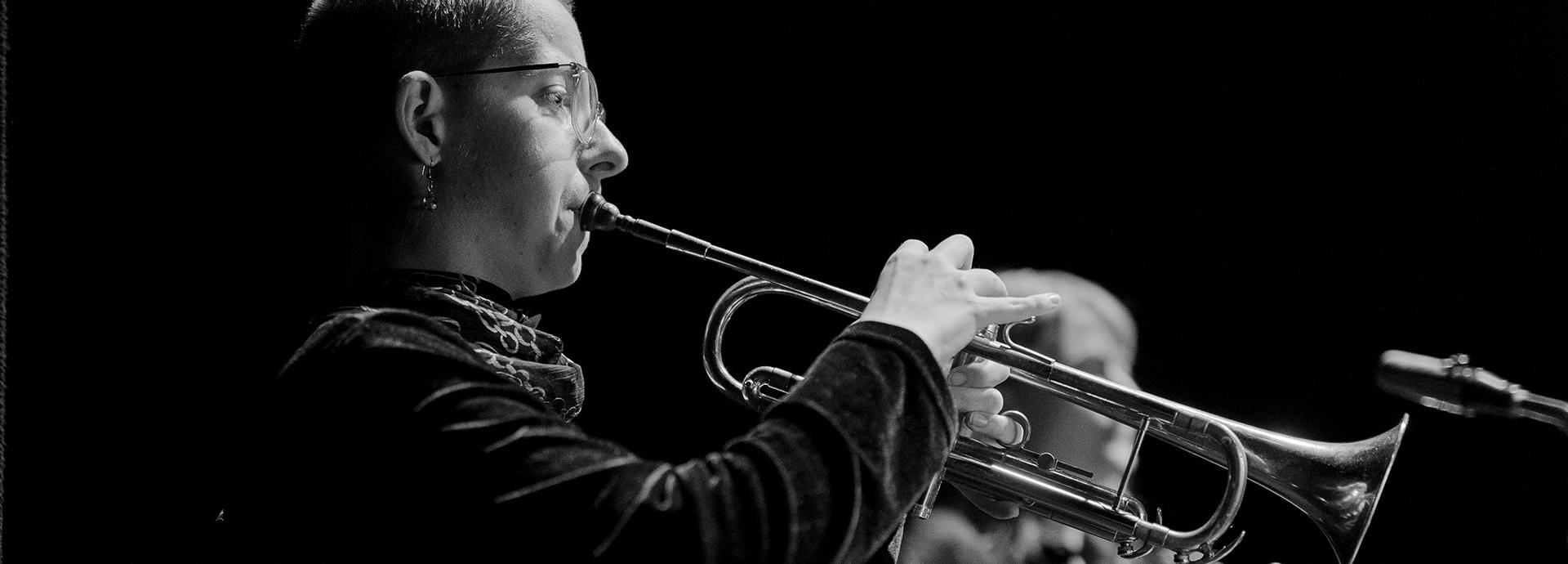 Black and white photo of Devina Boughton playing the trumpet