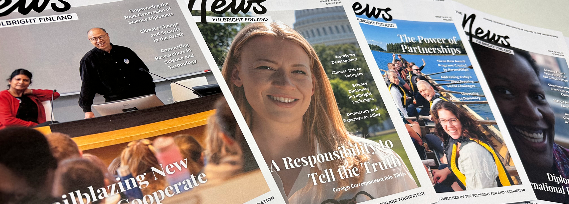 Selection of Fulbright Finland News magazine covers on a table