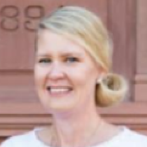 Photo of a woman with light hair in a bun