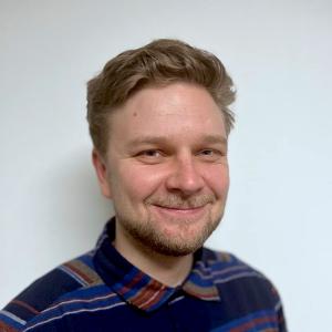 A person in a blue shirt smiling