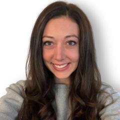 Woman with long dark hair wearing a grey sweater